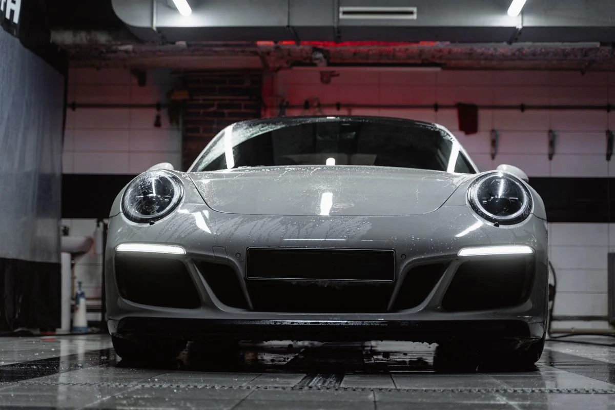 Glossy sports car in a dark studio