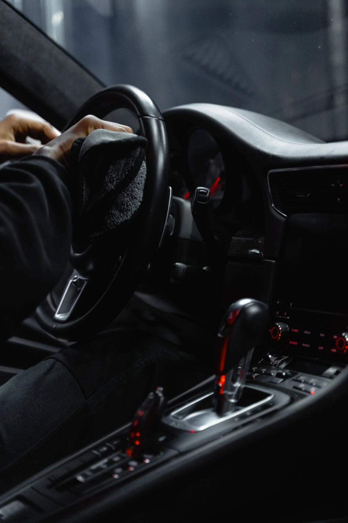 Dark leather car interior with red stitching