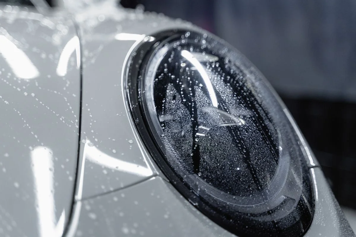 Headlamp with water beads on protective film